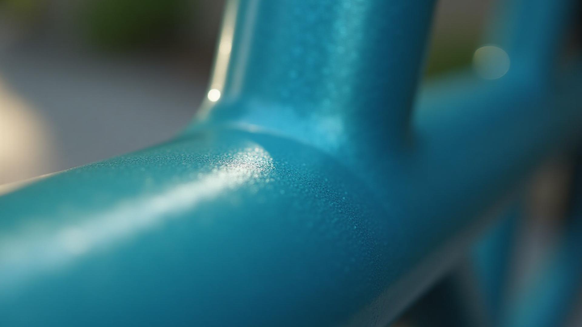 Close-up of a meticulously painted bicycle frame detail, showcasing vibrant color transitions.